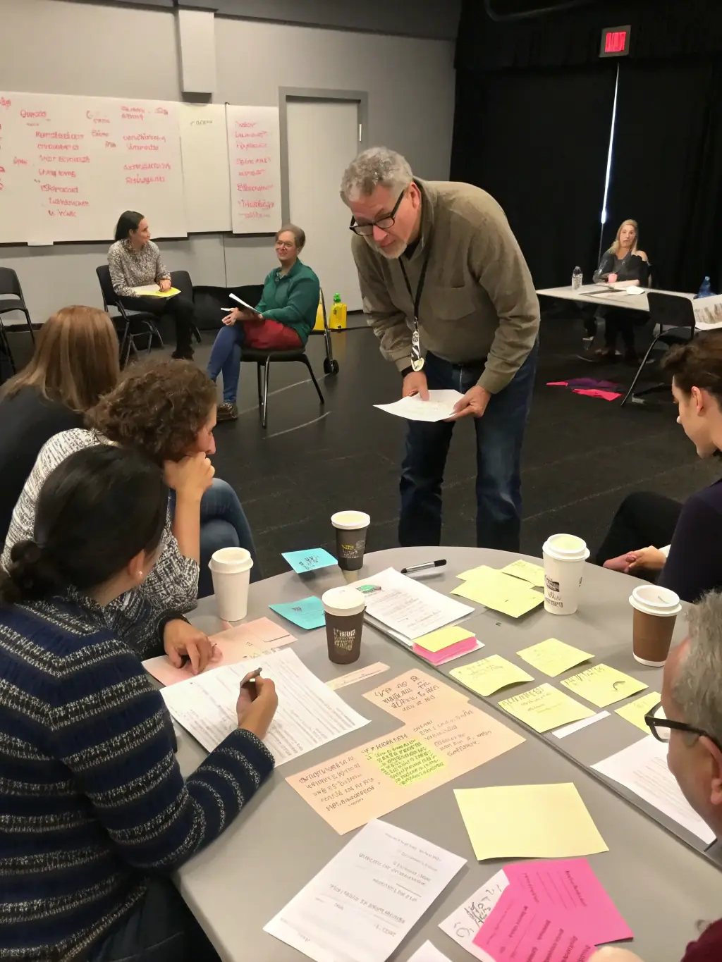 A touching photo of participants from different age groups collaborating on the Intergenerational Theater Project, creating and performing original plays, showcasing TOUS EN SCENE's efforts in strengthening community ties.