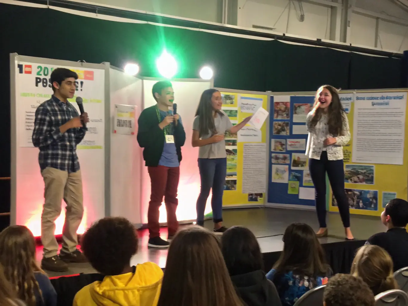 A heartwarming image of young artists displaying their work at the Youth Talent Showcase, highlighting the mentorship and support provided by TOUS EN SCENE.